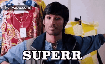 A Man Is Holding A Shirt In Front Of A Row Of Clothes And The Word Superr Is On The Shirt . GIF