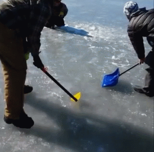 a man is holding a shovel in the water