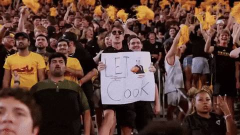 a man is holding a sign that says let cook