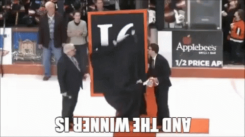 A Man Is Holding A Sign That Says T.g. On It GIF