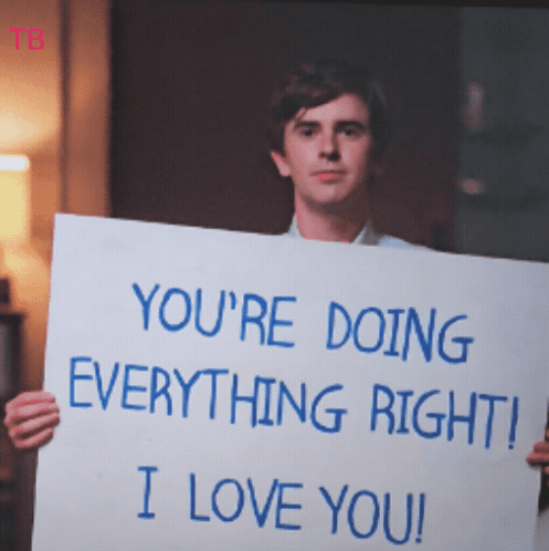 A Man Is Holding A Sign That Says " You 'Re Doing Everything Right I Love You " GIF
