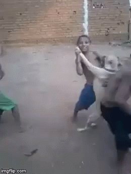 A Man Is Holding A Snake In His Hands While Another Man Holds A Rope . GIF