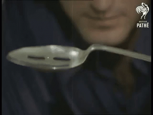 A Man Is Holding A Spoon In Front Of His Face And The Words Focus Are Visible GIF