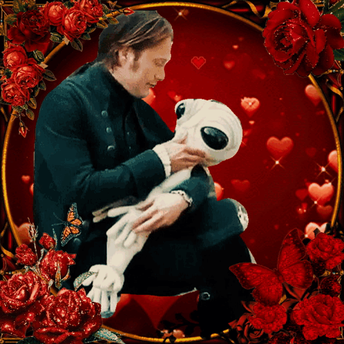 A Man Is Holding A Stuffed Animal Surrounded By Roses And Hearts GIF