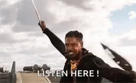 A Man Is Holding A Sword In The Air And Saying `` Listen Here ! '' GIF