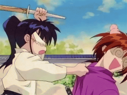 A Man Is Holding A Sword Over Another Man 'S Head . GIF
