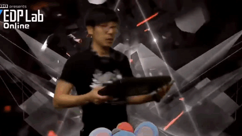 A Man Is Holding A Tablet In Front Of A Screen That Says Edplab Online GIF