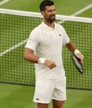 A Man Is Holding A Tennis Racket On A Tennis Court . GIF