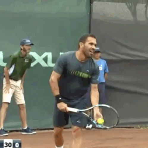 A Man Is Holding A Tennis Racquet On A Court With The Number 30 On The Bottom GIF