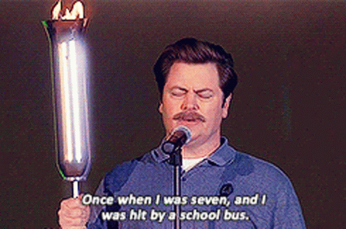A Man Is Holding A Torch In Front Of A Microphone And Says Once When I Was Seven GIF
