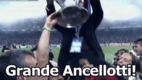 A Man Is Holding A Trophy In The Air With The Words Grande Ancellotti In The Corner GIF