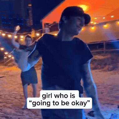 a man is holding a woman in his arms and says " girl who is going to be okay " on the bottom