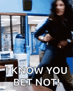 A Man Is Holding A Woman In His Arms In A Room And Says `` I Know You Bet Not '' . GIF