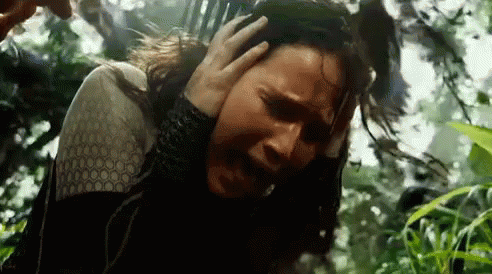 A Man Is Holding A Woman 'S Head In A Forest . GIF