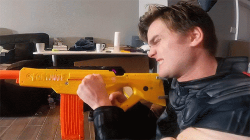 Man Holding Fortnite Yellow Toy Gun GIF