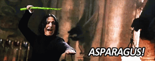 A Man Is Holding An Asparagus In His Hand With The Words Asparagus In The Background GIF