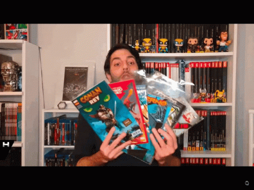 Man Holding Conan Roy Comic Book GIF