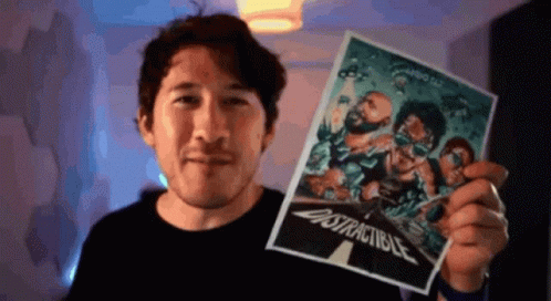 A Man Is Holding Up A Poster That Says " Distractable " On It GIF