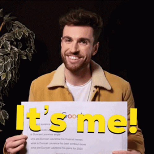 A Man Is Holding Up A Sign That Says It 'S Me GIF