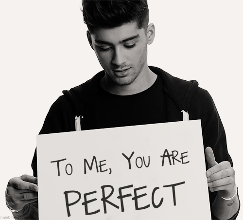 A Man Is Holding Up A Sign That Says To Me You Are Perfect GIF
