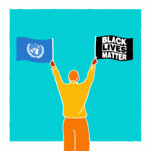 A Man Is Holding Up Two Flags And A Sign That Says Black Lives Matter GIF