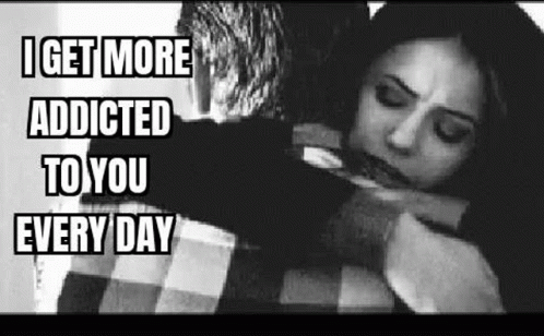A Man Is Hugging A Woman In A Black And White Photo With The Caption `` I Get More Addicted To You Every Day '' . GIF