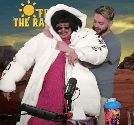 A Man Is Hugging A Woman In Front Of A Sign That Says Off The Road GIF