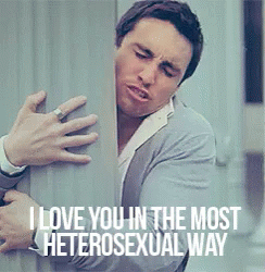 A Man Is Hugging Another Man With The Words " I Love You In The Most Heterosexual Way " On The Bottom GIF