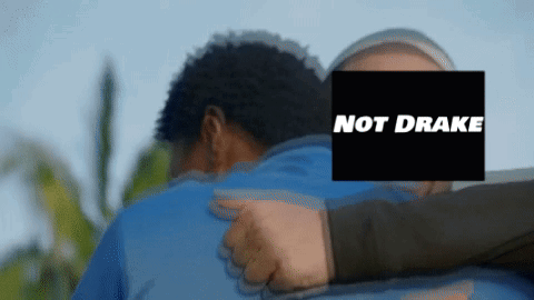 A Man Is Hugging Another Man With The Words Not Drake On The Screen GIF