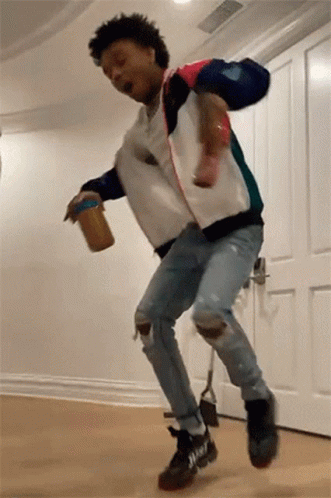A Man Is Jumping In The Air While Holding A Can Of Peanut Butter . GIF