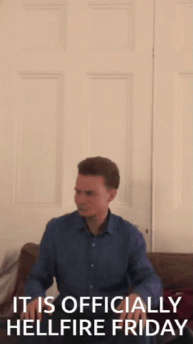 A Man Is Jumping In The Air With The Words " It Is Officially Hellfire Friday " Behind Him GIF