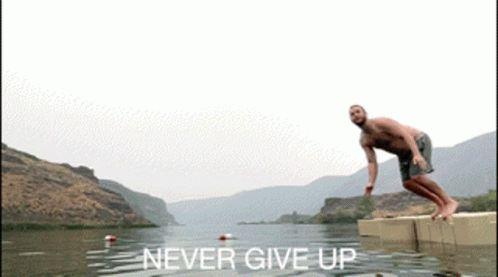 A Man Is Jumping Into A Lake With The Words " Never Give Up " Above Him GIF
