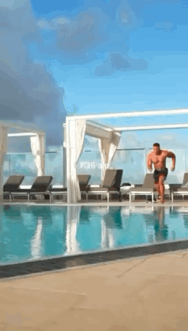 a man is jumping into a swimming pool at 1:36