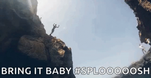 A Man Is Jumping Off A Cliff Into A Cave With The Words `` Bring It Baby '' . GIF