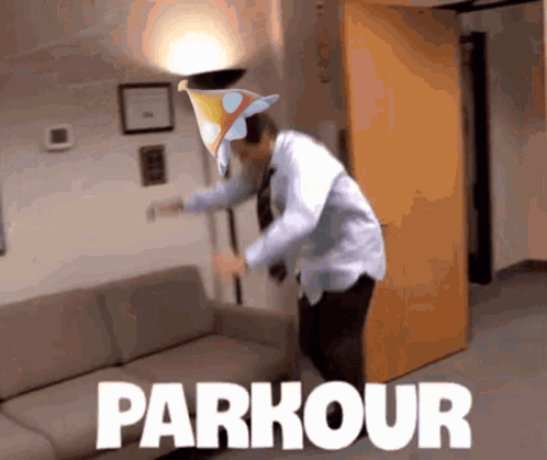 A Man Is Jumping Over A Couch And The Word Parkour Is On The Floor GIF