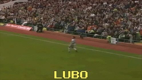 A Man Is Kicking A Soccer Ball On A Field With The Word Lubo On The Bottom Right GIF