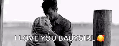 A Man Is Kissing A Woman On The Forehead While Hugging Her . GIF