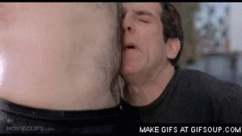 A Man Is Kissing Another Man 'S Stomach In A Movie Scene . GIF