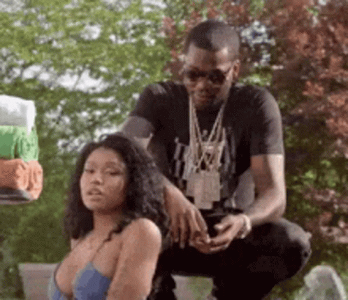 A Man Is Kneeling Down Next To A Woman In A Blue Bra . GIF