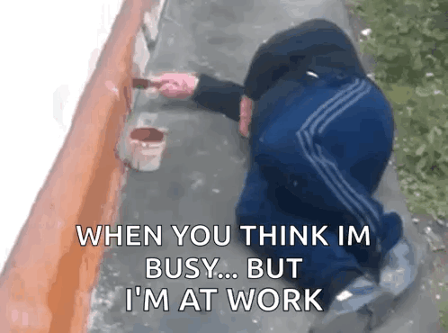 A Man Is Kneeling Down While Painting A Wall With A Brush And A Bucket Of Paint . GIF