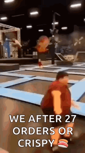 A Man Is Kneeling On A Trampoline With The Words `` We After 27 Orders Or Crispy '' Written On It . GIF
