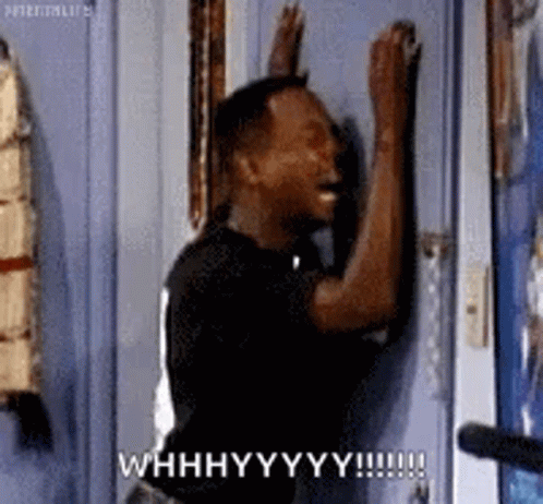 A Man Is Knocking On A Door And Making A Funny Face With His Hands . GIF