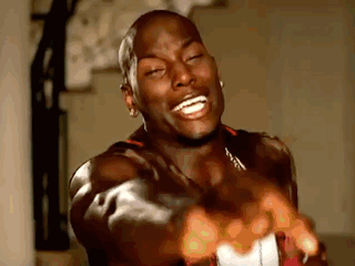 A Man Is Laughing And Pointing At The Camera With His Hands . GIF