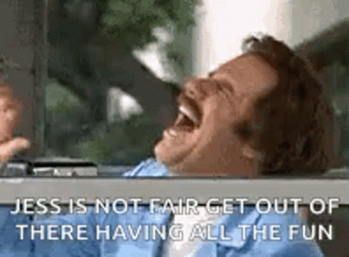 A Man Is Laughing While Sitting In A Car With His Mouth Wide Open . GIF