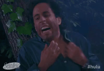 A Man Is Laughing While Sitting In A Tree . GIF