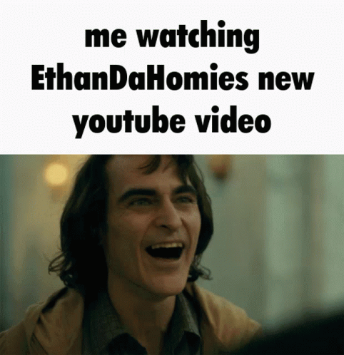 a man is laughing with the words me watching ethandahomies new youtube video below him