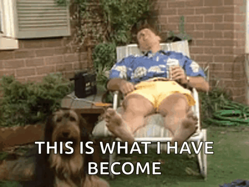 Man Lying In Chair Next To Dog GIF