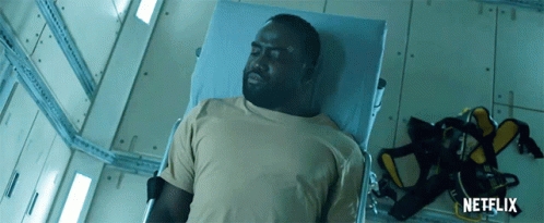 A Man Is Laying In A Hospital Bed With A Netflix Logo On The Bottom GIF