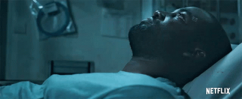 A Man Is Laying In A Hospital Bed With A Netflix Logo On The Bottom GIF