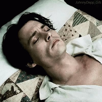 A Man Is Laying In Bed With His Eyes Closed And The Words Johnny Depp Gifs On The Bottom GIF
